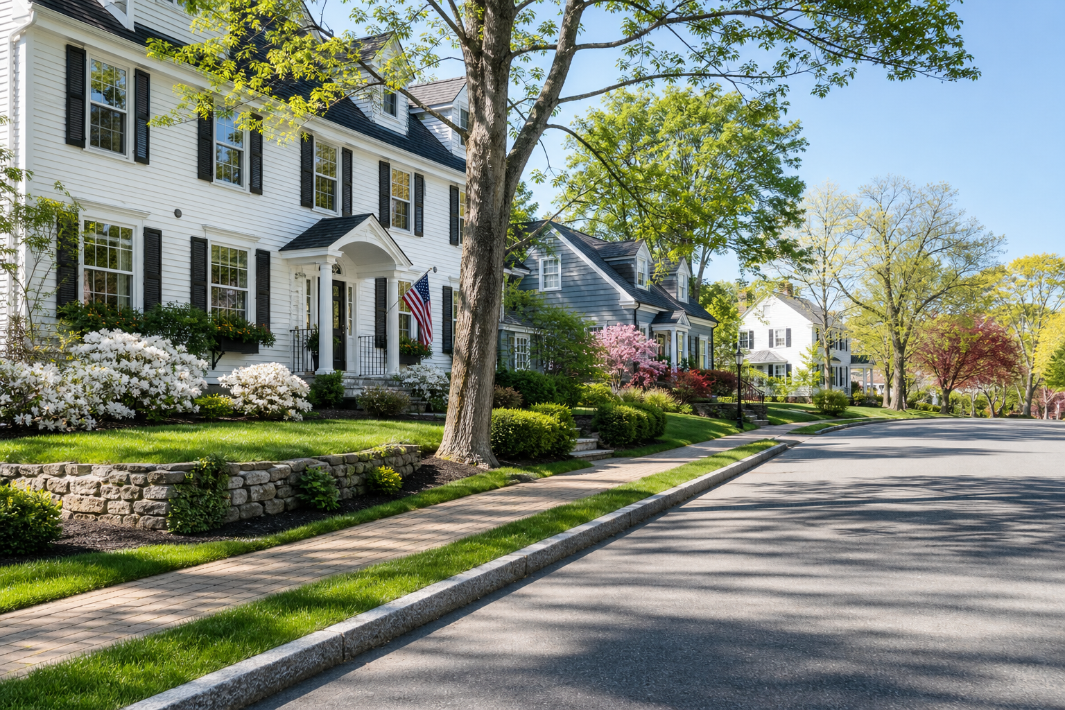 Polished residential neighborhood street in Medfield, Massachusetts with well-kept homes and tree-lined sidewalks in soft daylight