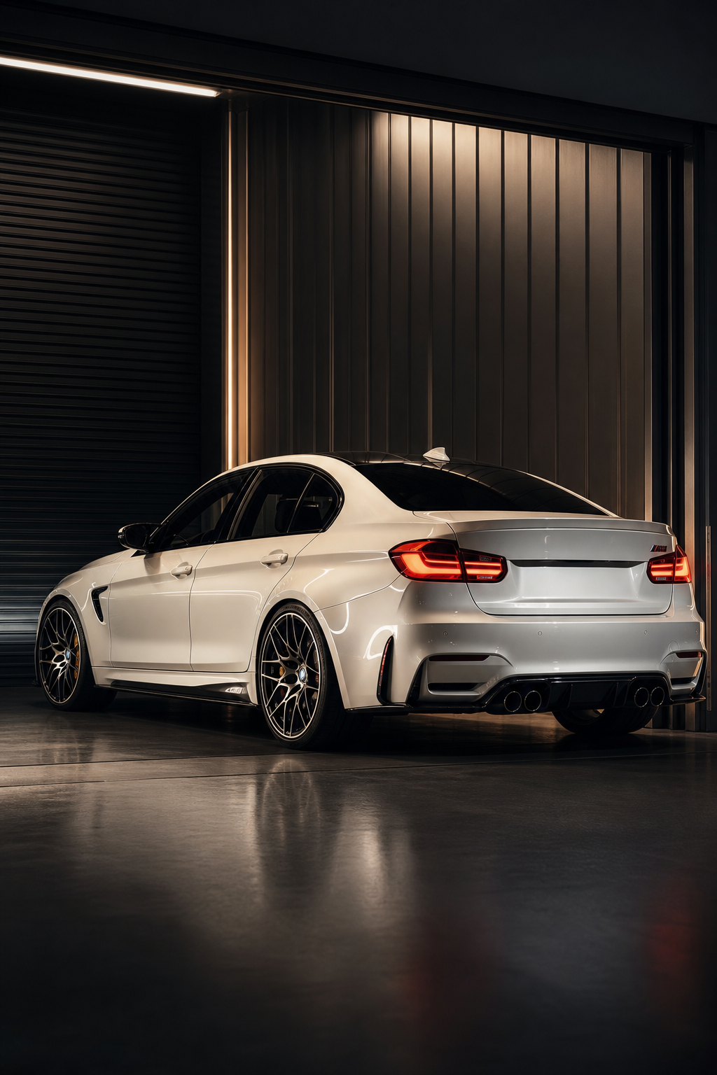 Pearl white performance saloon positioned under cinematic side lighting in a secure unit