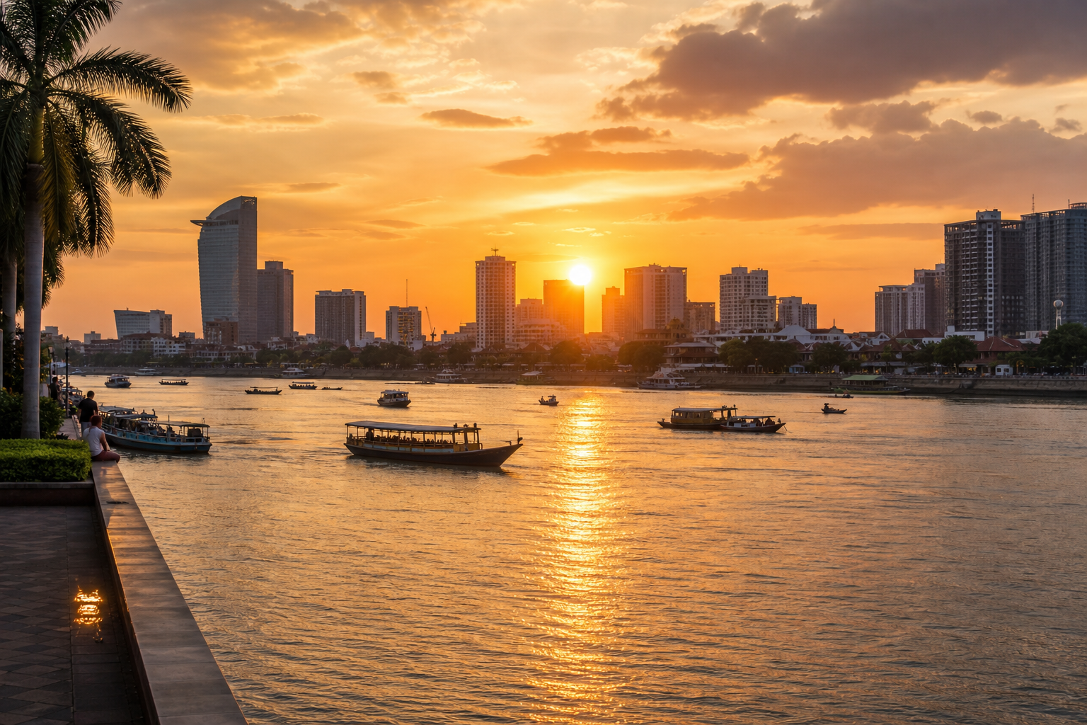 Sunset view of the Tonlé Sap riverside in Phnom Penh with golden light and city skyline