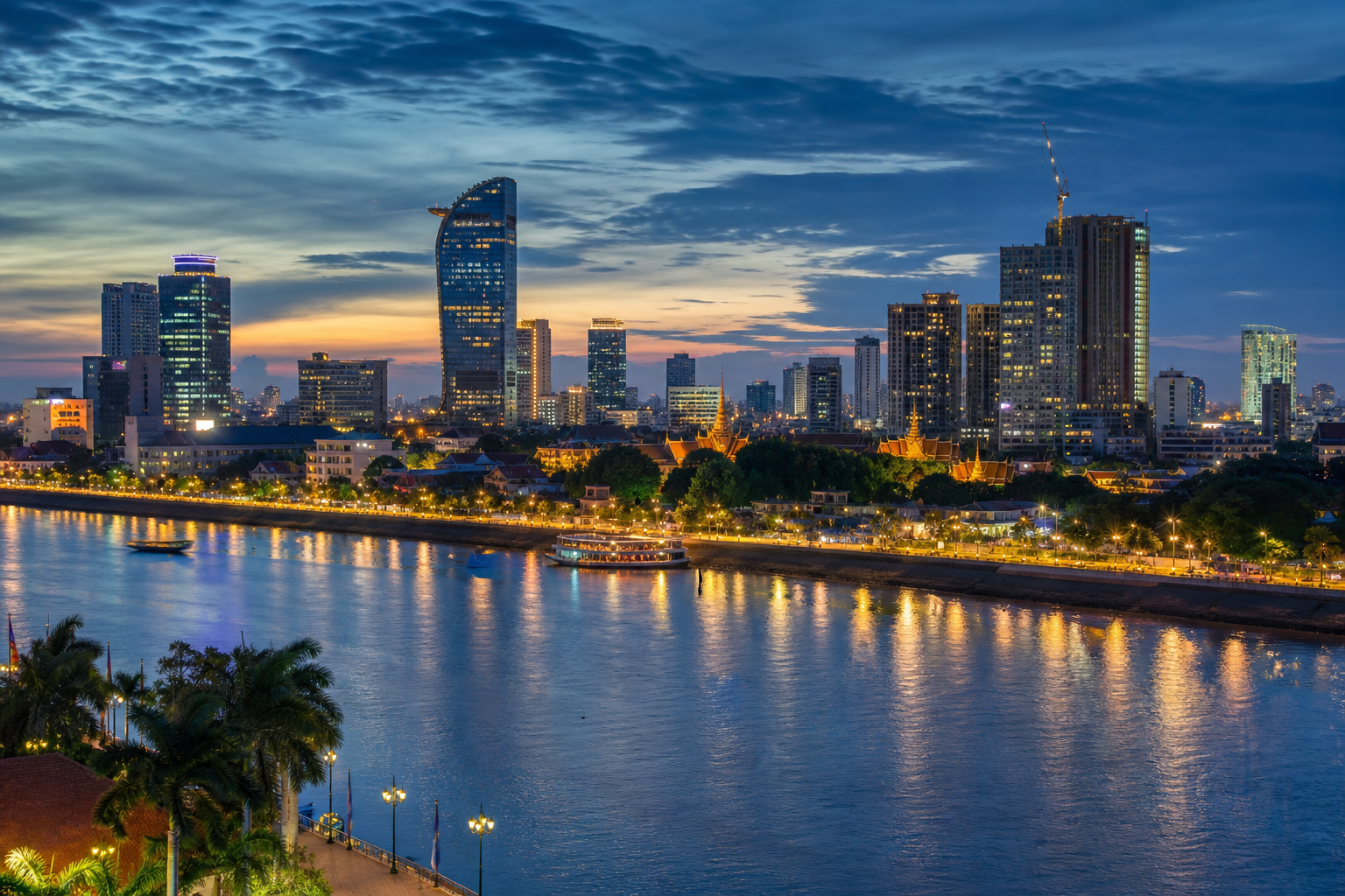 Modern Phnom Penh skyline at dusk with the Mekong river and glowing city lights