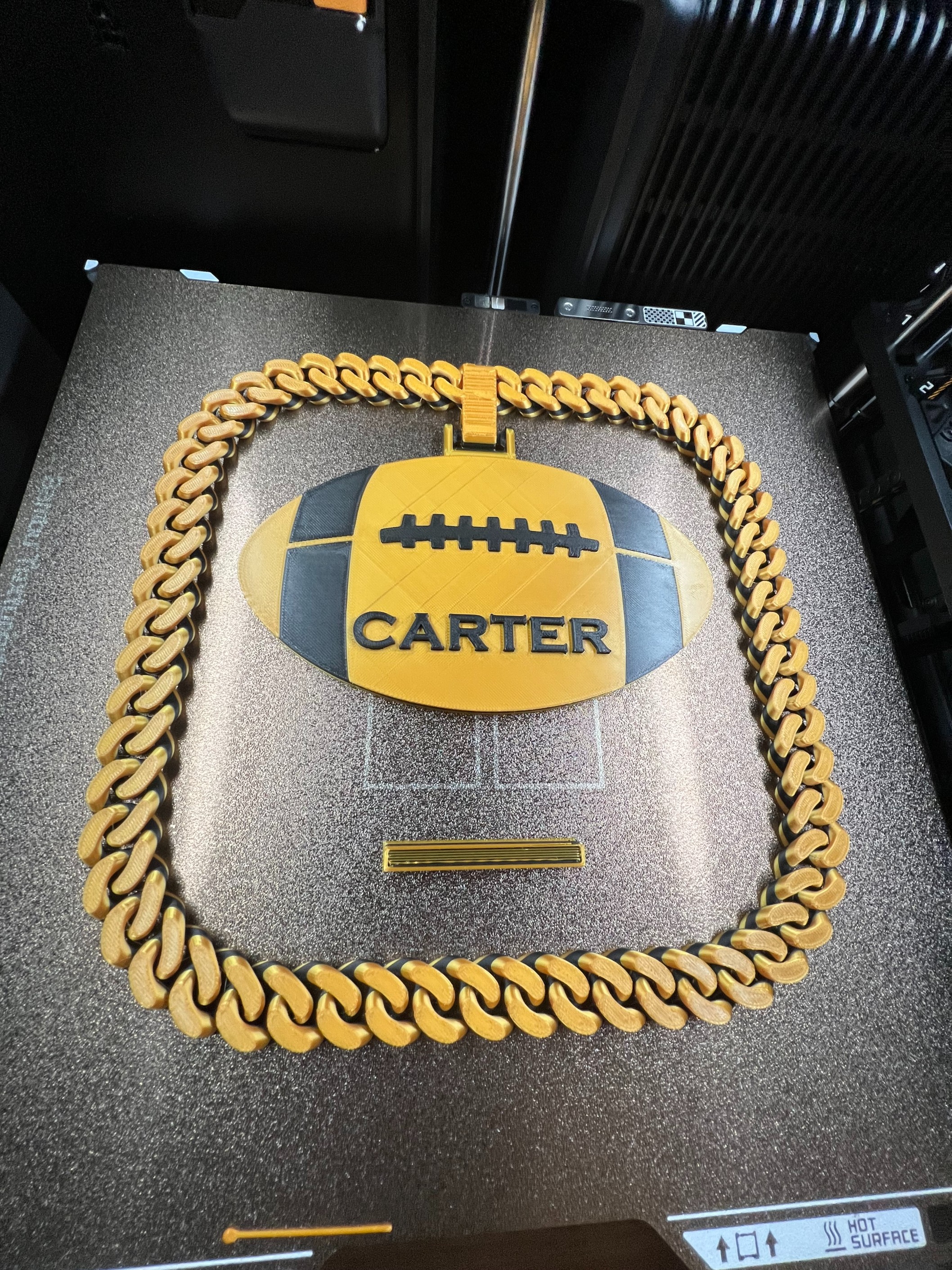 Hype Chain 3D-printed gold and black football pendant necklace with CARTER text