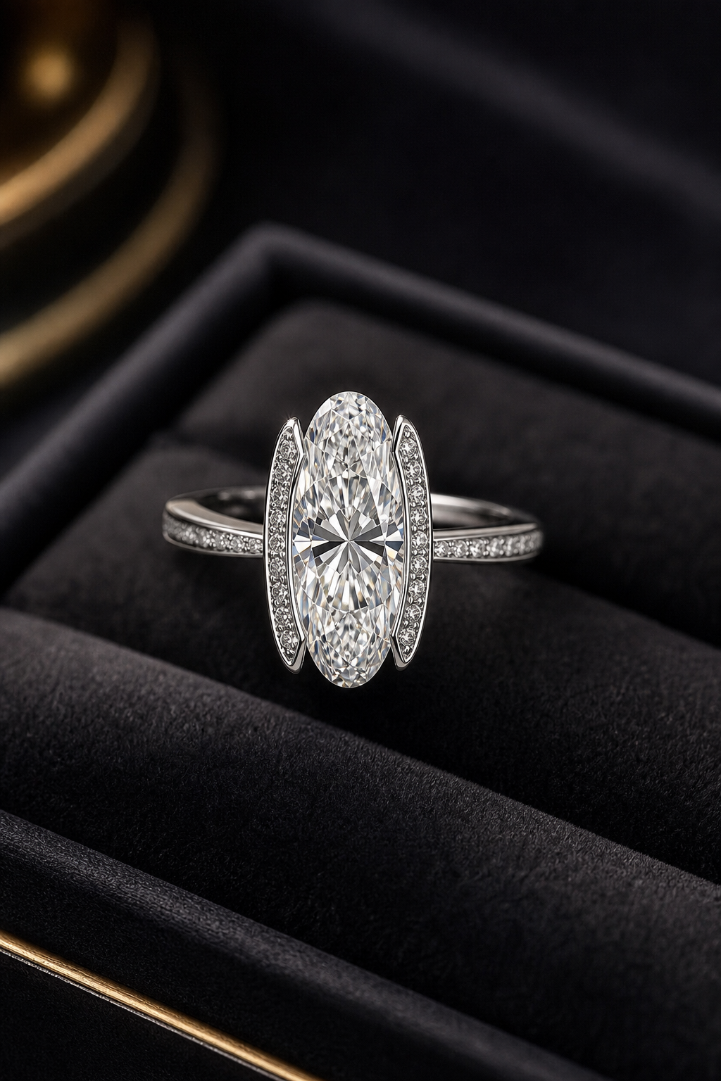 Elegant handcrafted diamond ring with a modern elongated setting resting on a dark velvet tray with soft studio lighting
