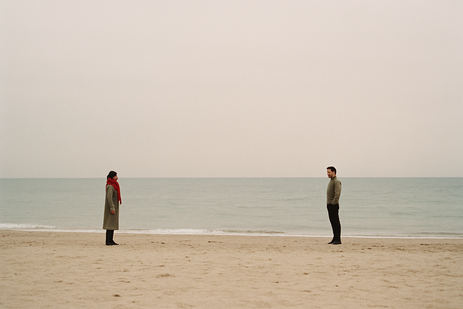 Film photograph of a couple on an empty off-season beach in Odesa with muted blue sea