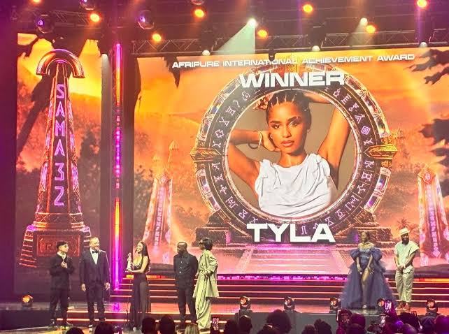 Live African music awards moment with stage lighting, performers, and audience atmosphere