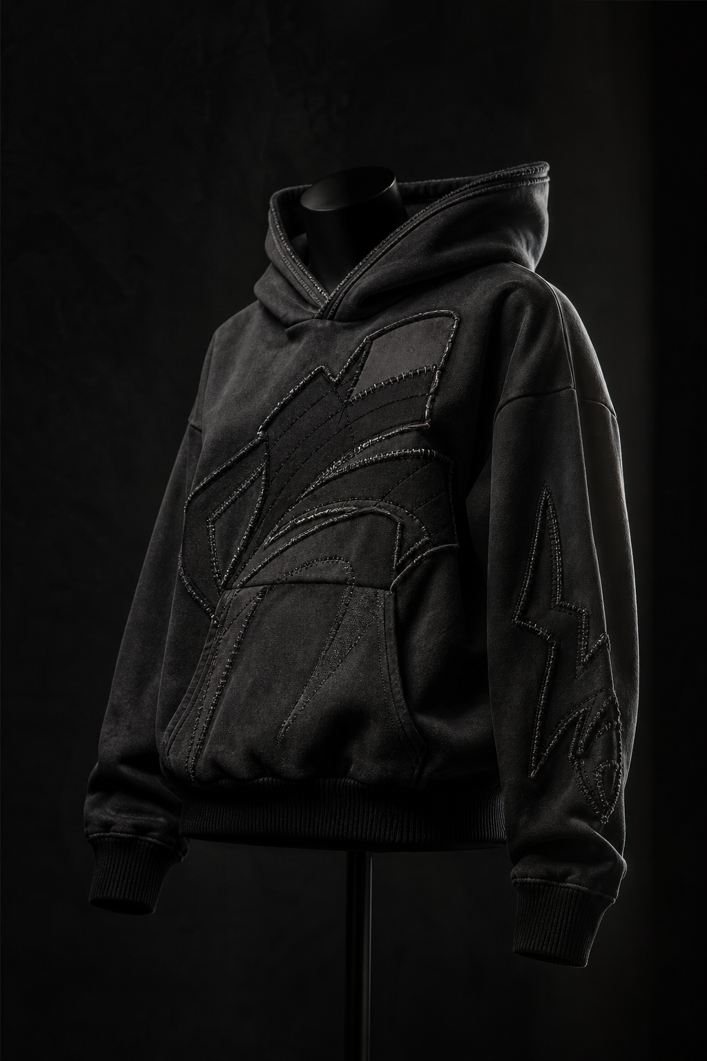 Premium custom hoodie display in a dark editorial studio setup with detailed stitching and modern streetwear fit