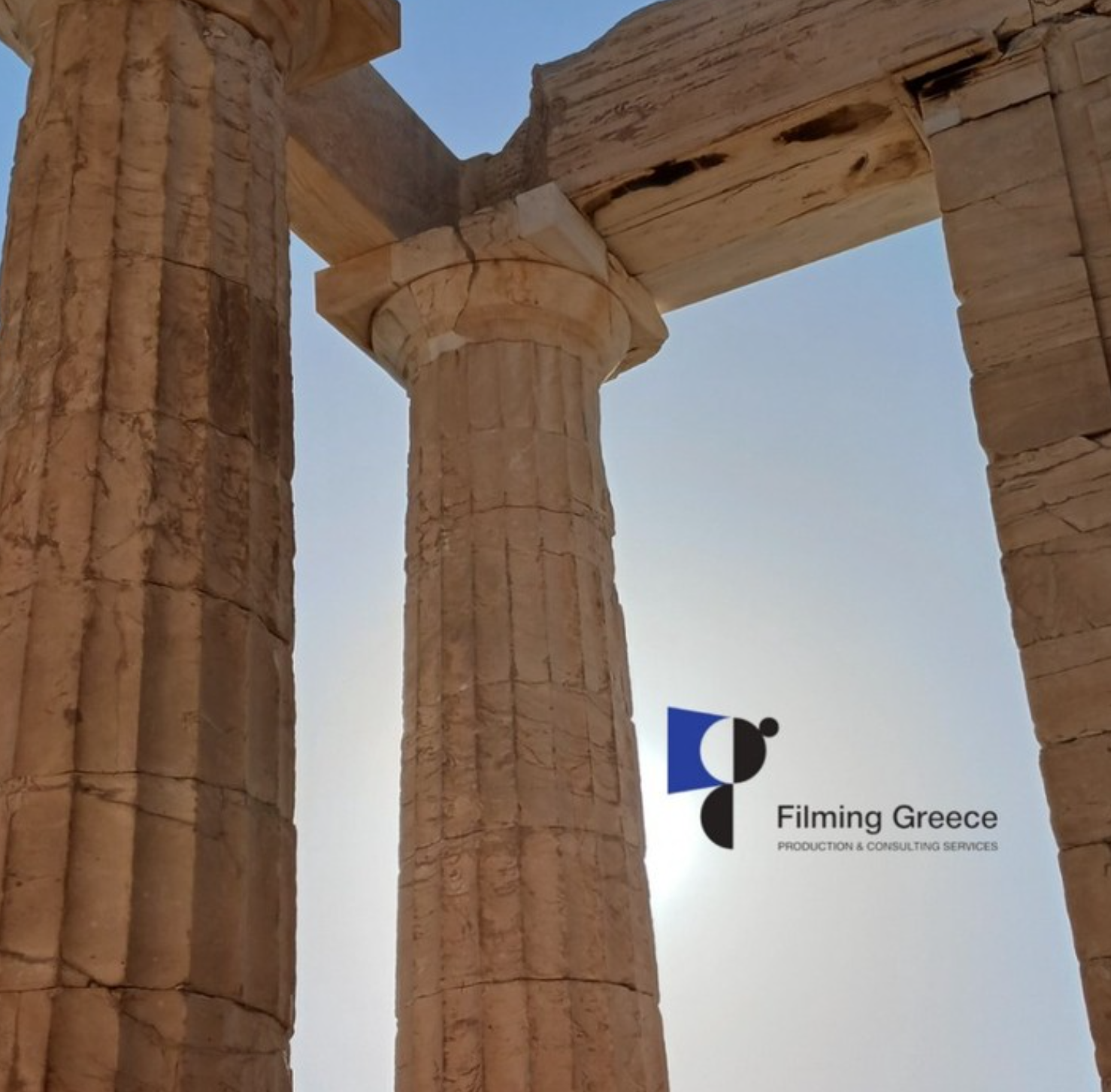 Close architectural detail of ancient columns with bright sky, illustrating on-site framing and structural texture capture