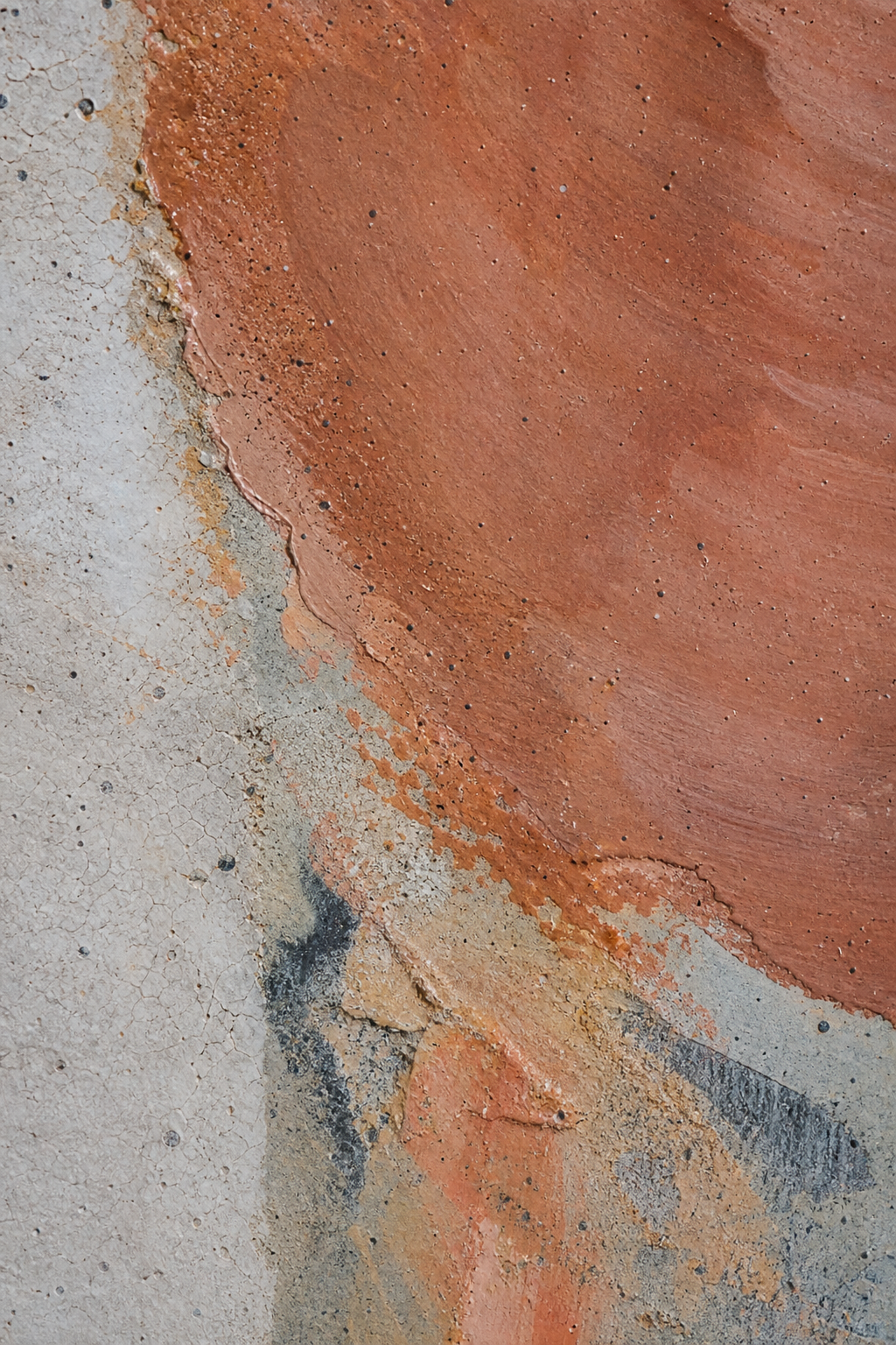 Macro detail showing mineral texture and soft terracotta glaze