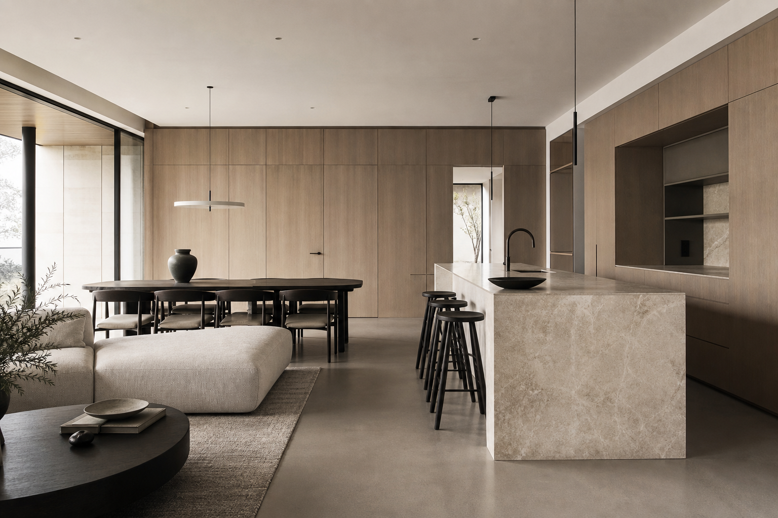 Refined naturally lit interior with pale oak wall paneling, honed stone island, and soft concrete textures