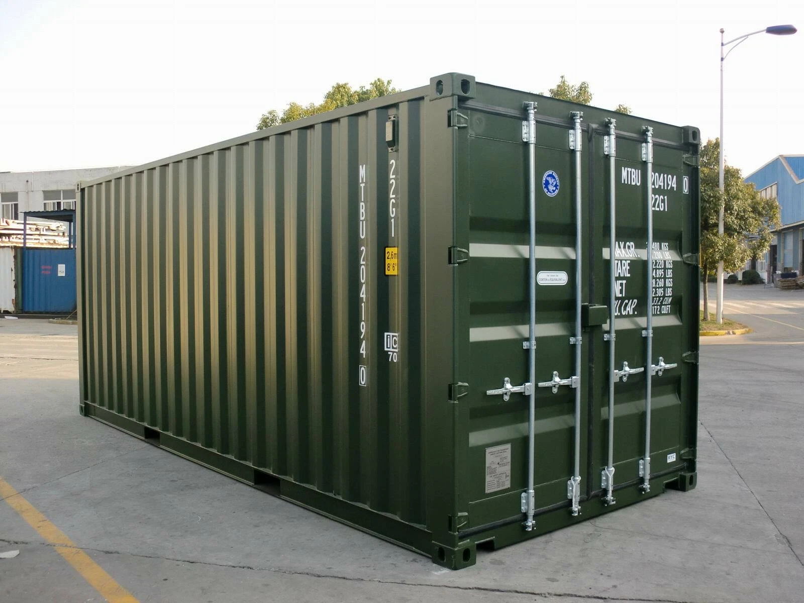 15ft steel container positioned beside a logistics yard fence