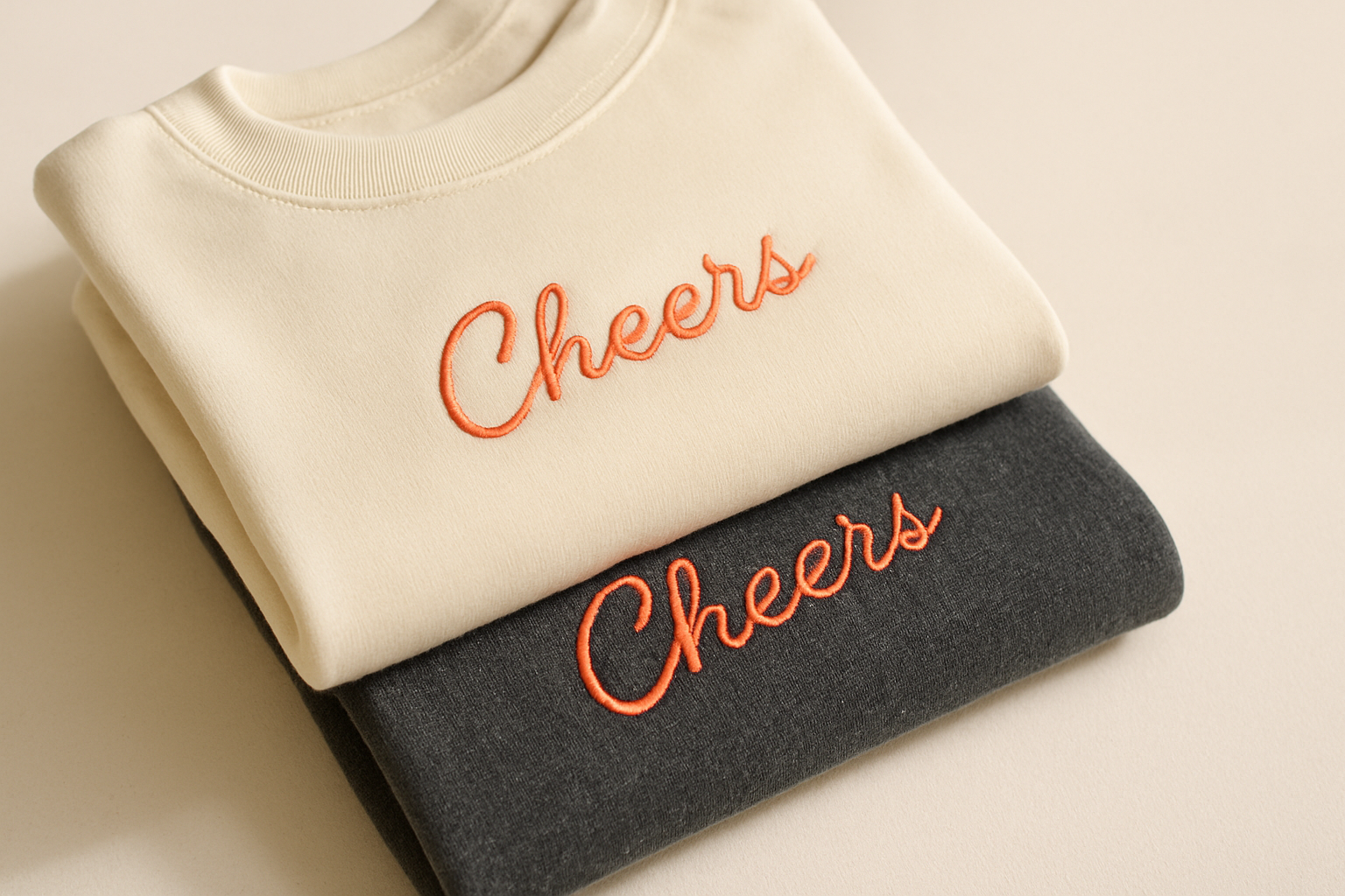 Close-up of embroidered custom apparel with textured stitching and folded garments