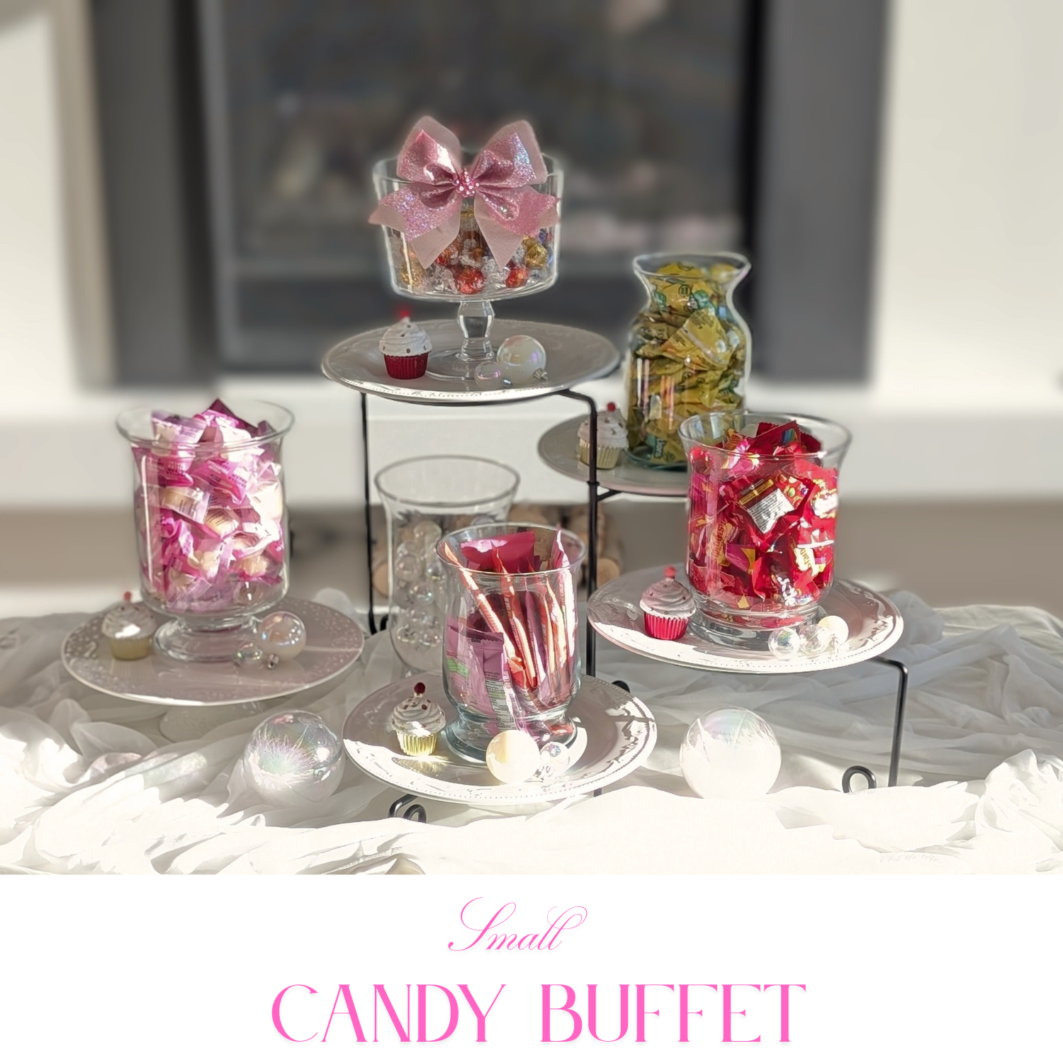 Mid-size candy buffet with layered risers, coordinated labels, and balanced centerpiece styling