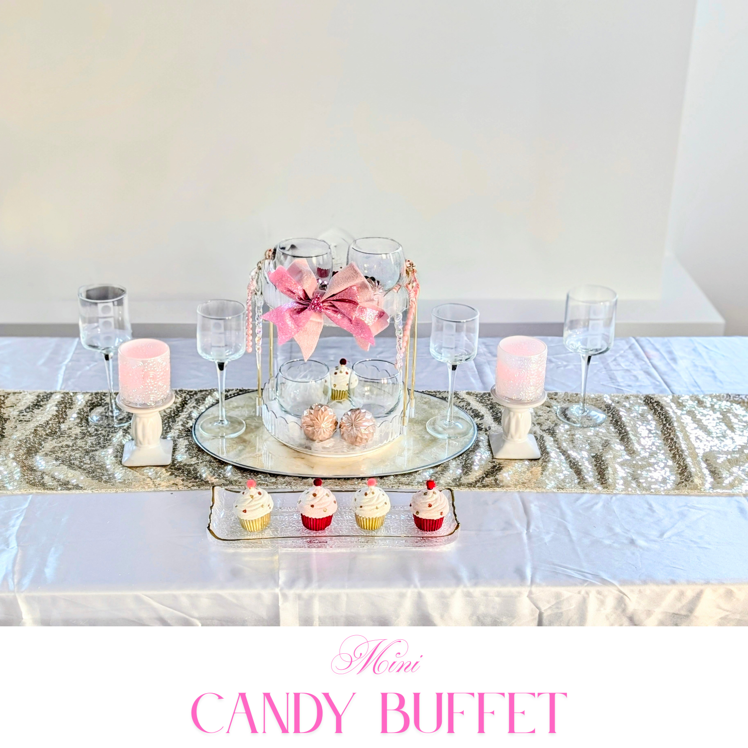 Compact candy buffet with glass jars, blush sweets, and a soft floral accent for intimate celebrations