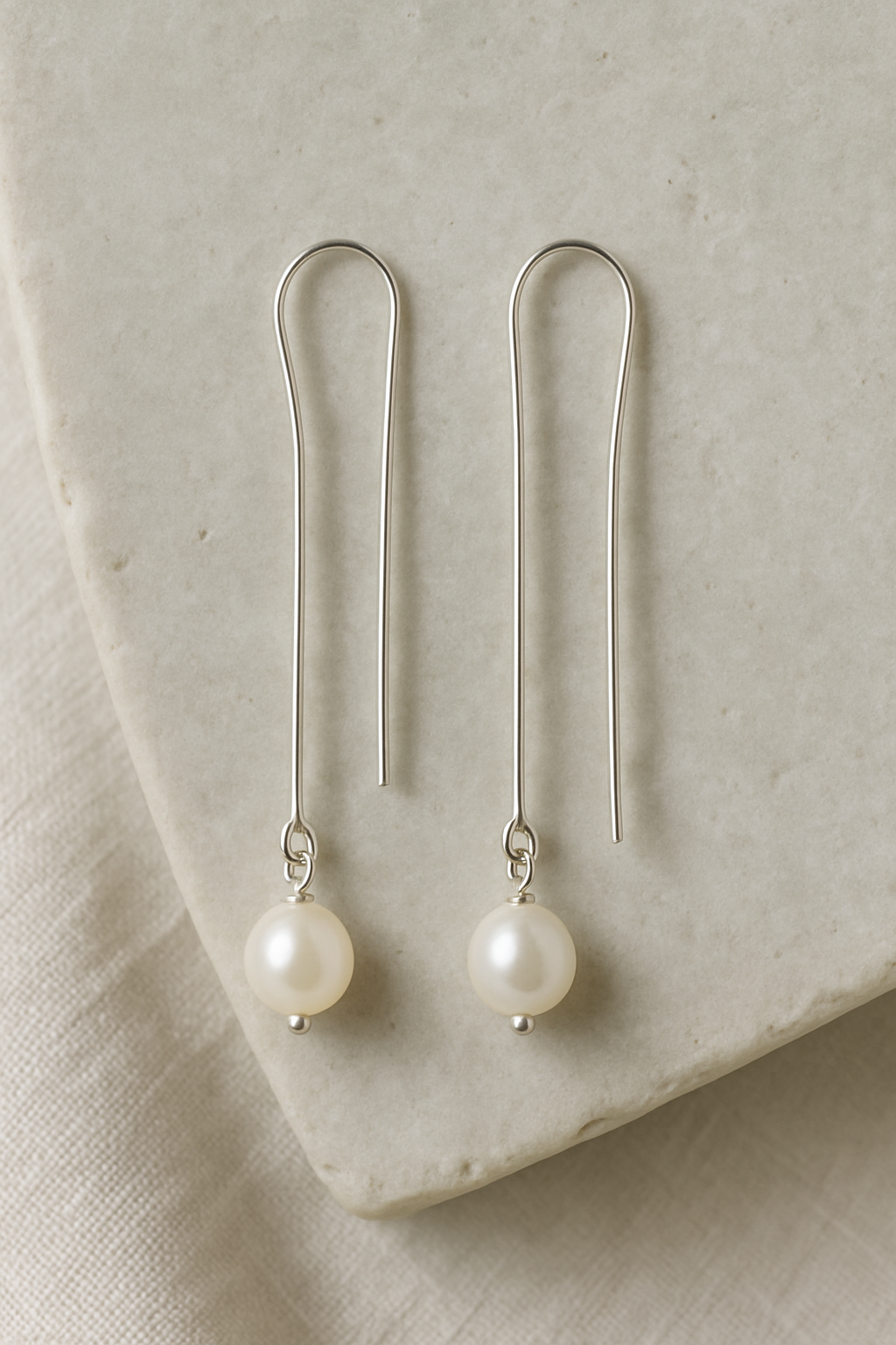 Pair of silver drop earrings with pearls