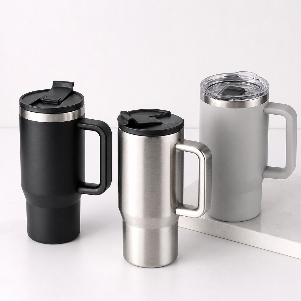 Stainless steel travel mugs with ergonomic handles and flip-top lids displayed in a premium product lineup