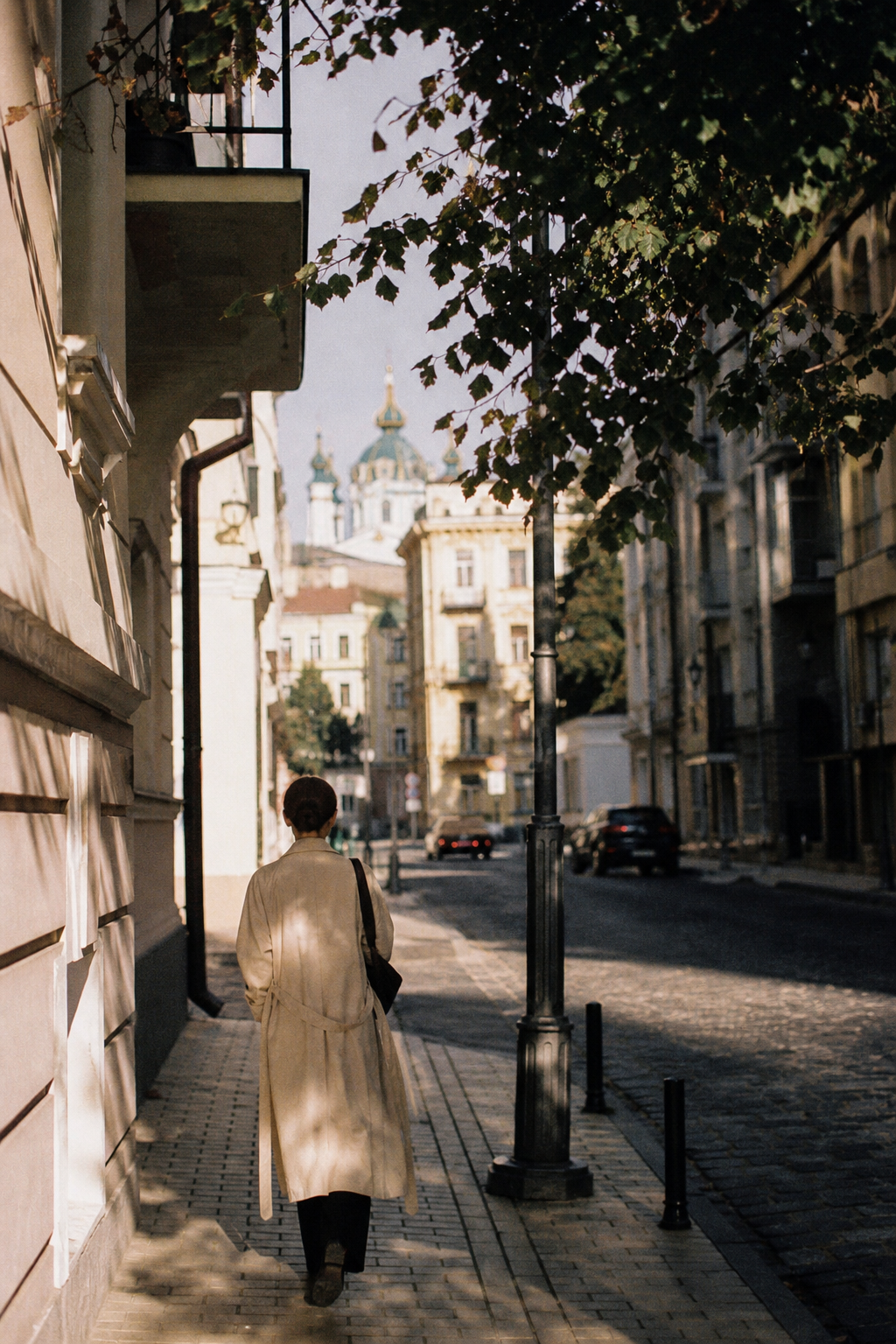 Grainy 35mm film street photography scene in Kyiv with muted colors
