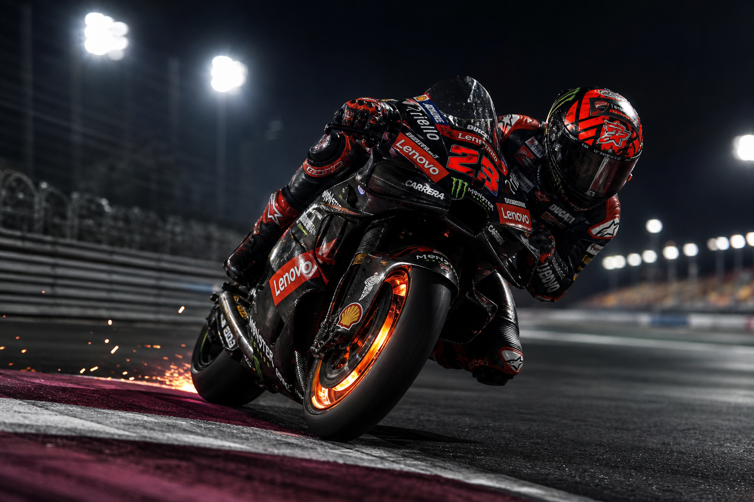 MotoGP rider braking hard into a floodlit corner with glowing brake discs