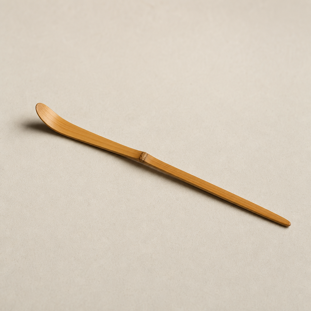 Slender bamboo tea scoop with a soft honey tone and tapered tip