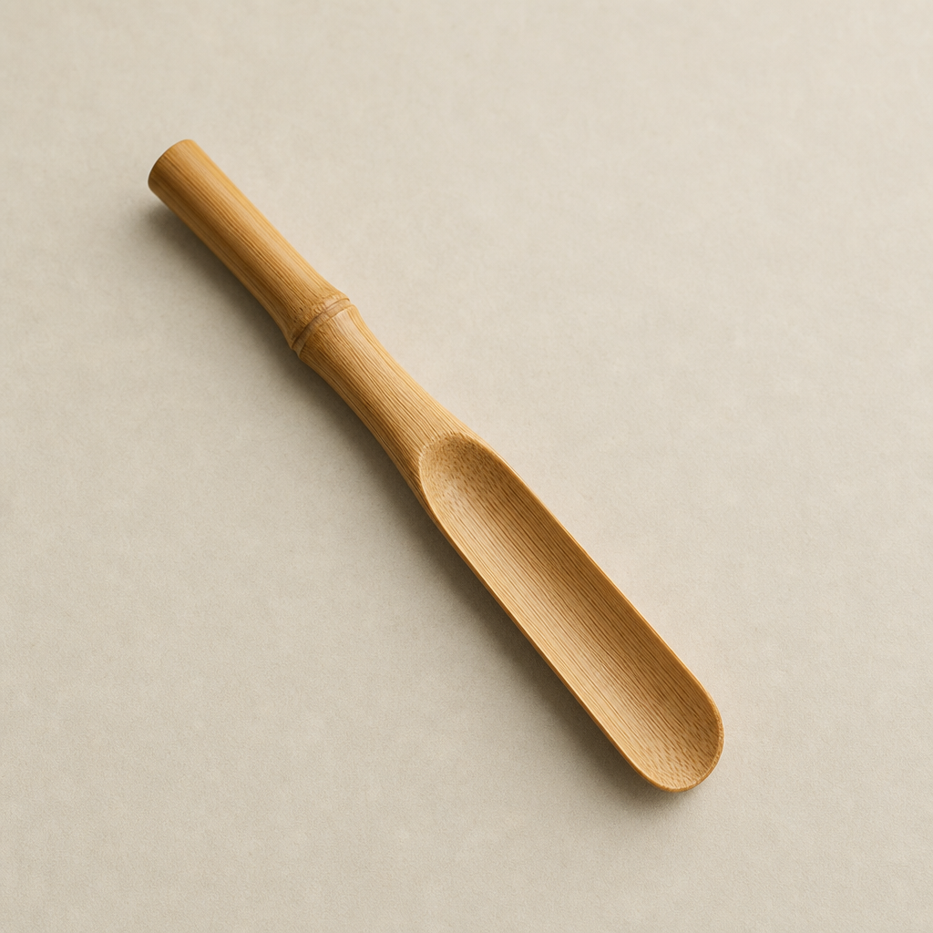 Top view of a bamboo tea scoop showing fine grain and narrow bowl