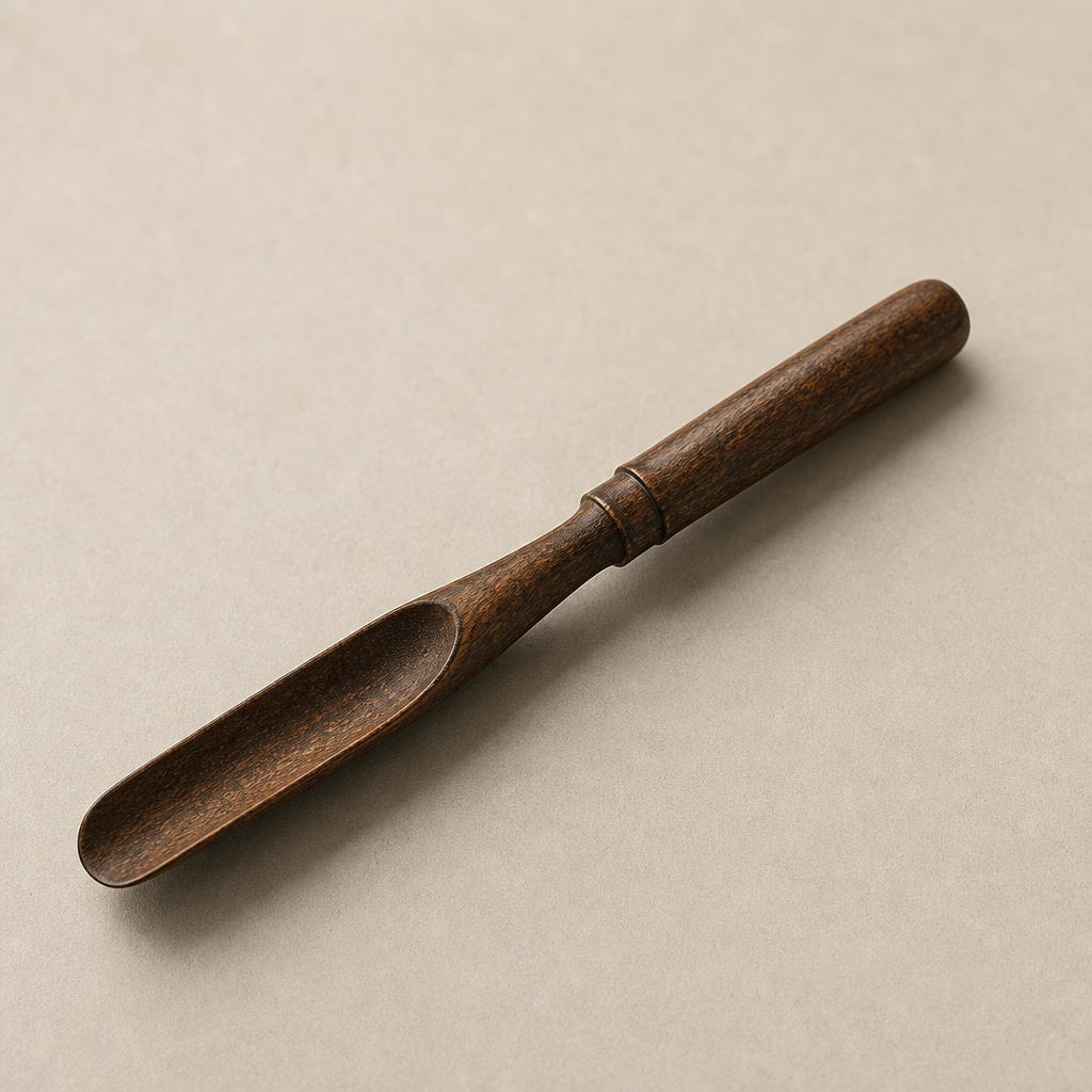 Bamboo tea scoop with a darker toasted tone and rounded handle