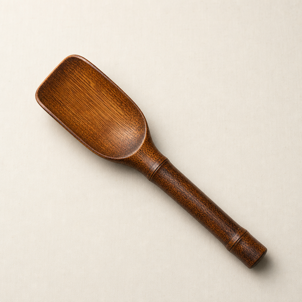 Top view of the scoop showing wider bowl and warm amber grain