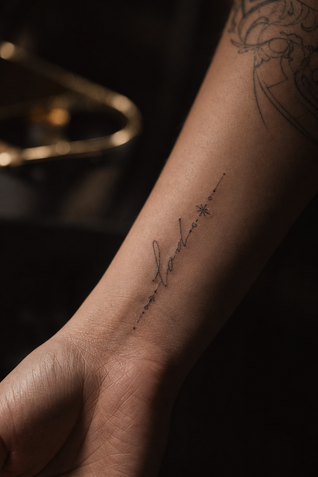 Close-up fine line script and micro-detail tattoo with delicate needlework on wrist