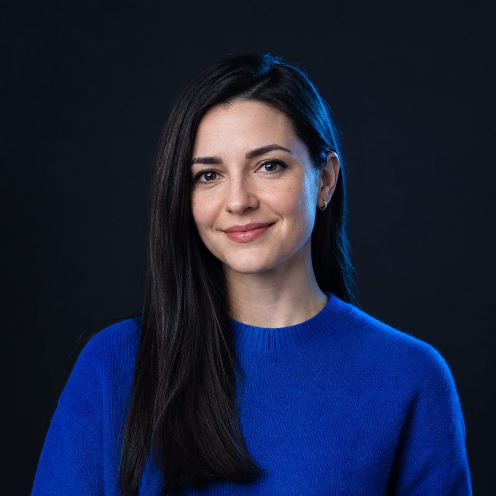 Sofiia Tkachenko, with straight dark hair and a cobalt knit top