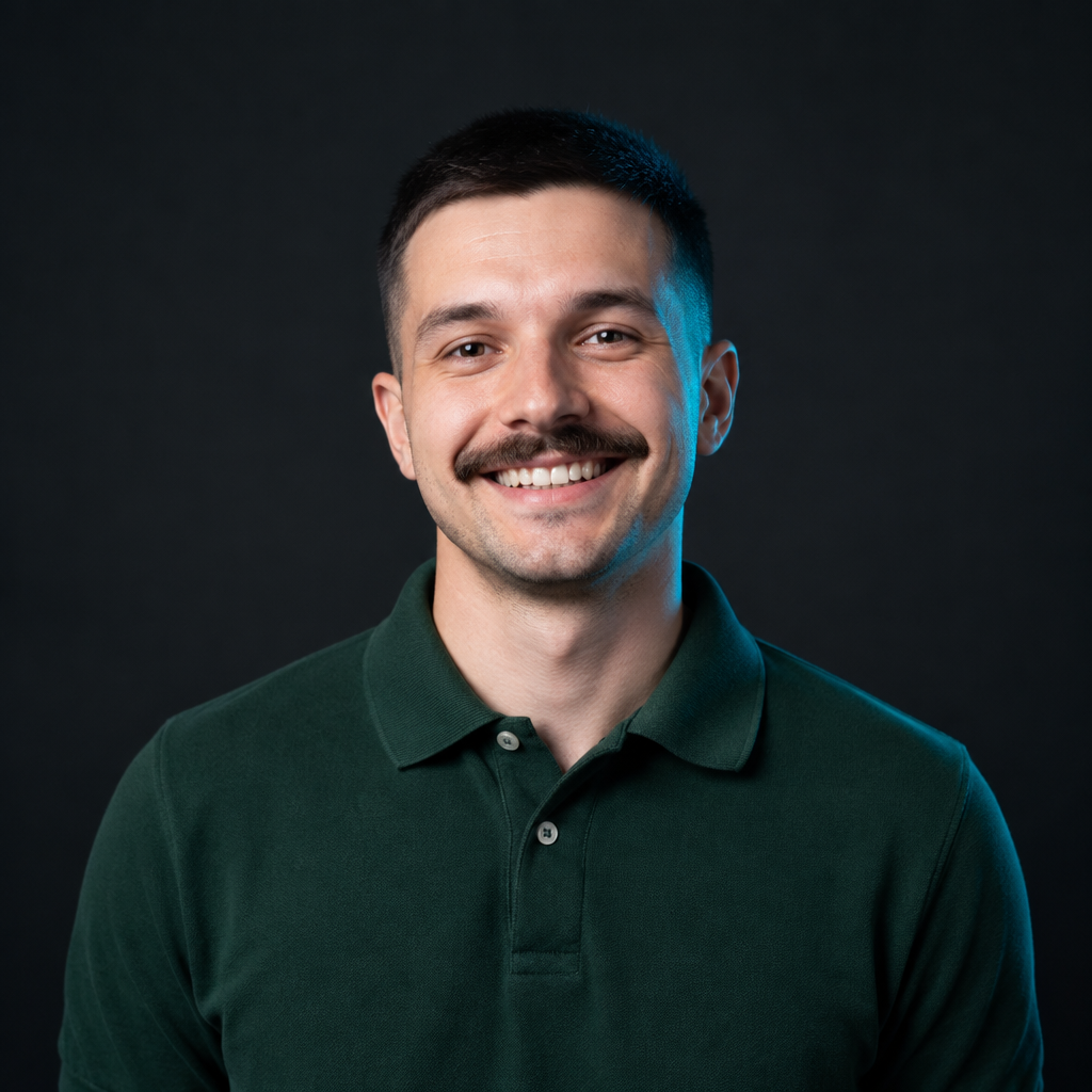 Taras Savchuk, with close-cropped black hair, a mustache, and a forest-green polo