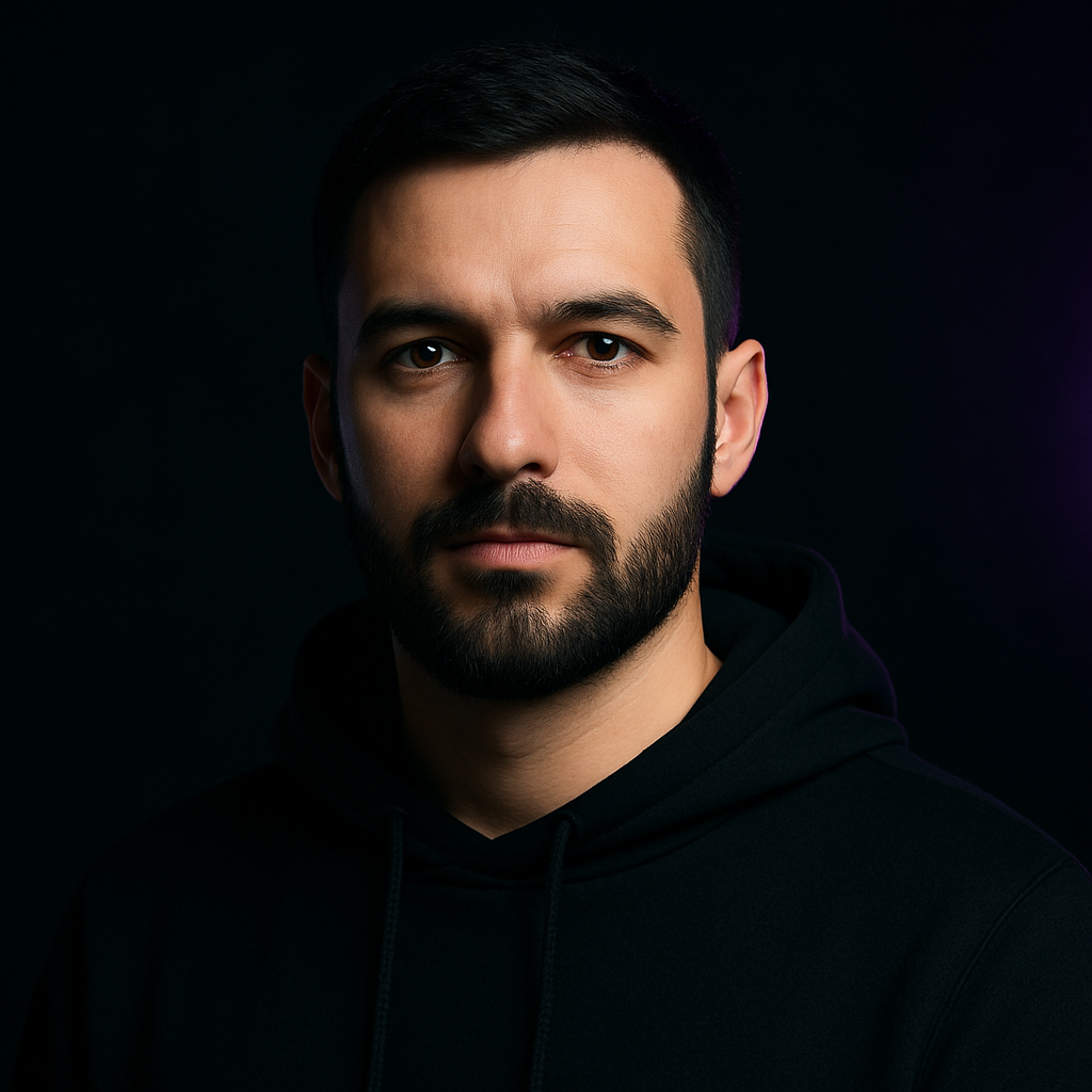Portrait of Artem Bondar, a young man with a beard and a black hoodie