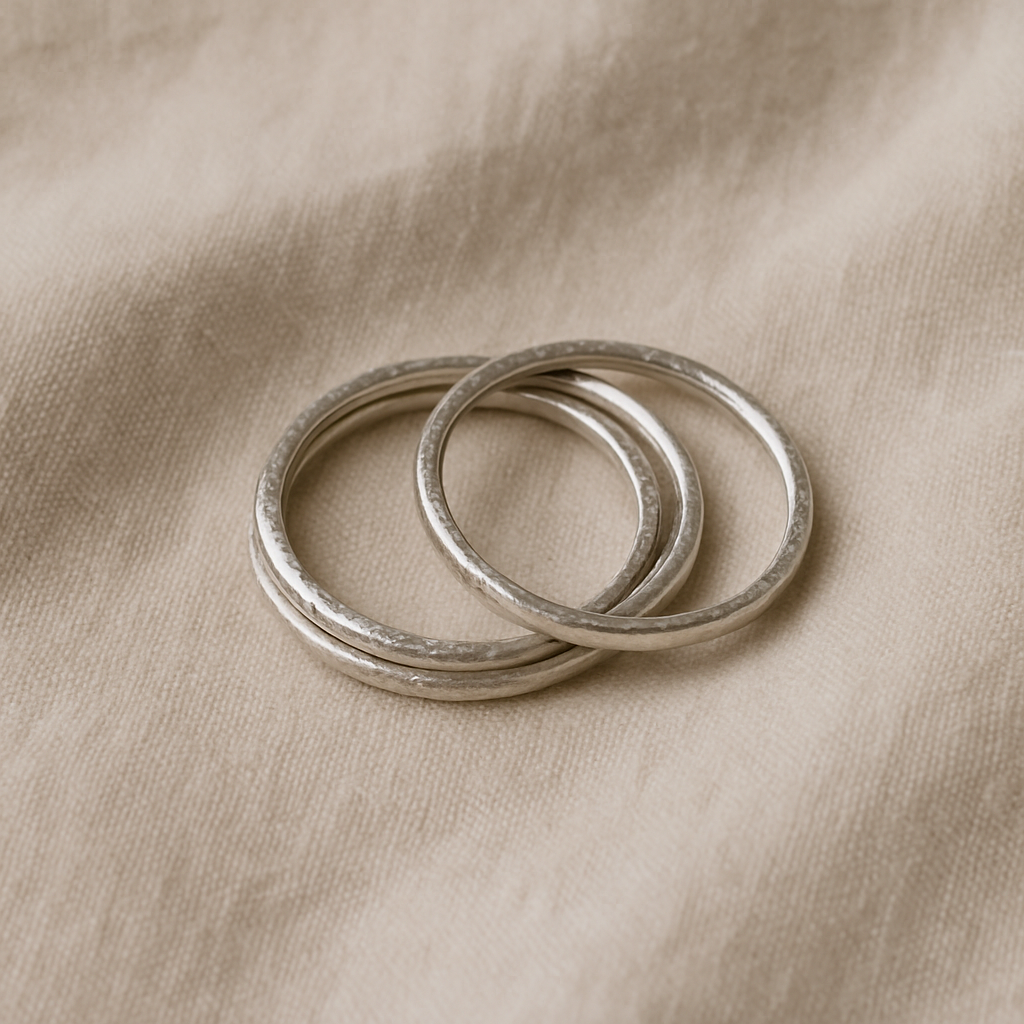 Stacked thin silver bands with subtle texture