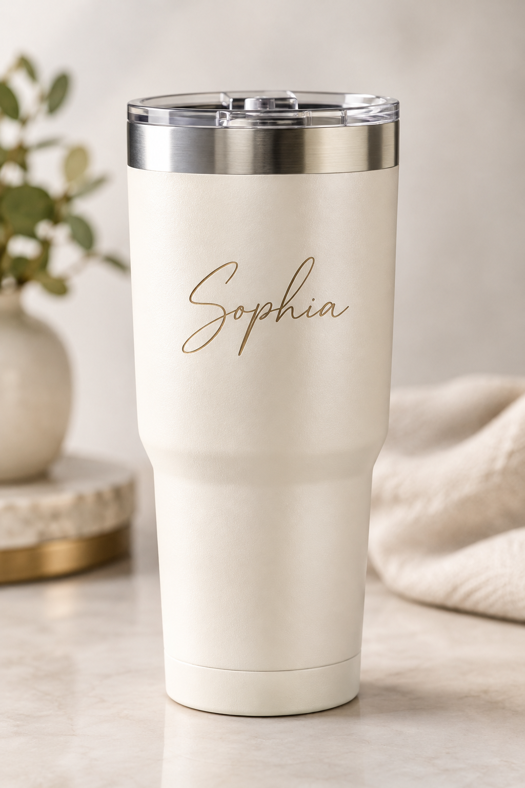 Close-up of a premium custom tumbler with personalized name engraving and metallic lid