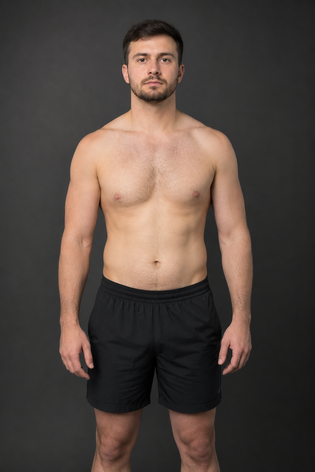 Before: adult male client with a broader waist and beginner-level muscle definition, standing in a neutral studio portrait.