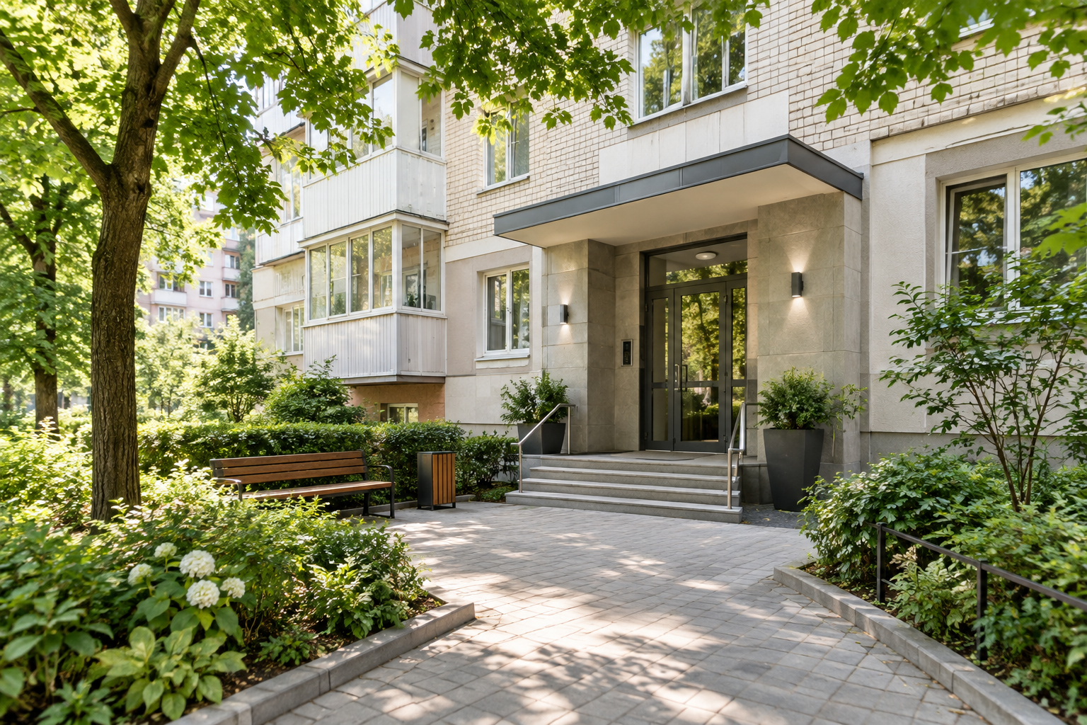 Well-kept Kyiv apartment building entrance framed by mature trees