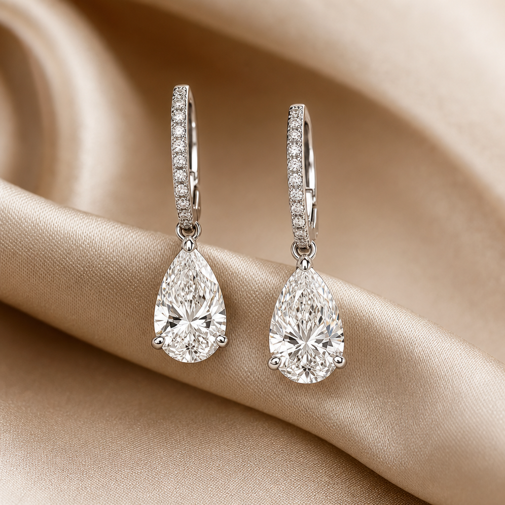 Pair of pear-shaped diamond drop earrings in white gold with slender pave9 hooks