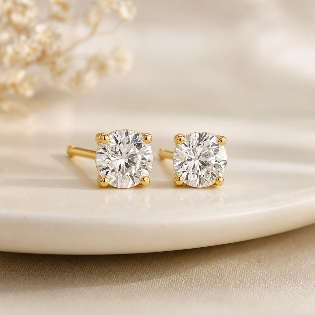Minimalist round diamond stud earrings set in yellow gold prongs