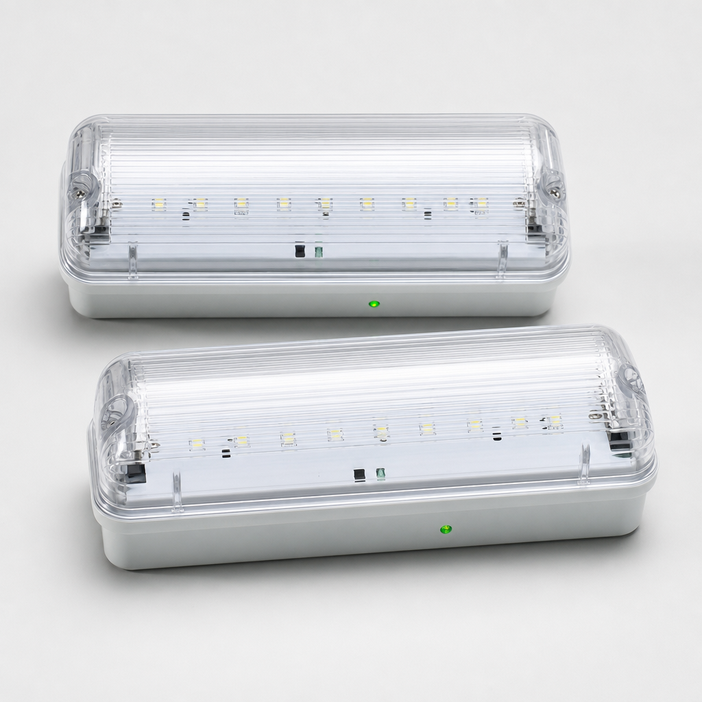 Emergency LED bulkhead lights with clear covers and green indicator lights on a light background
