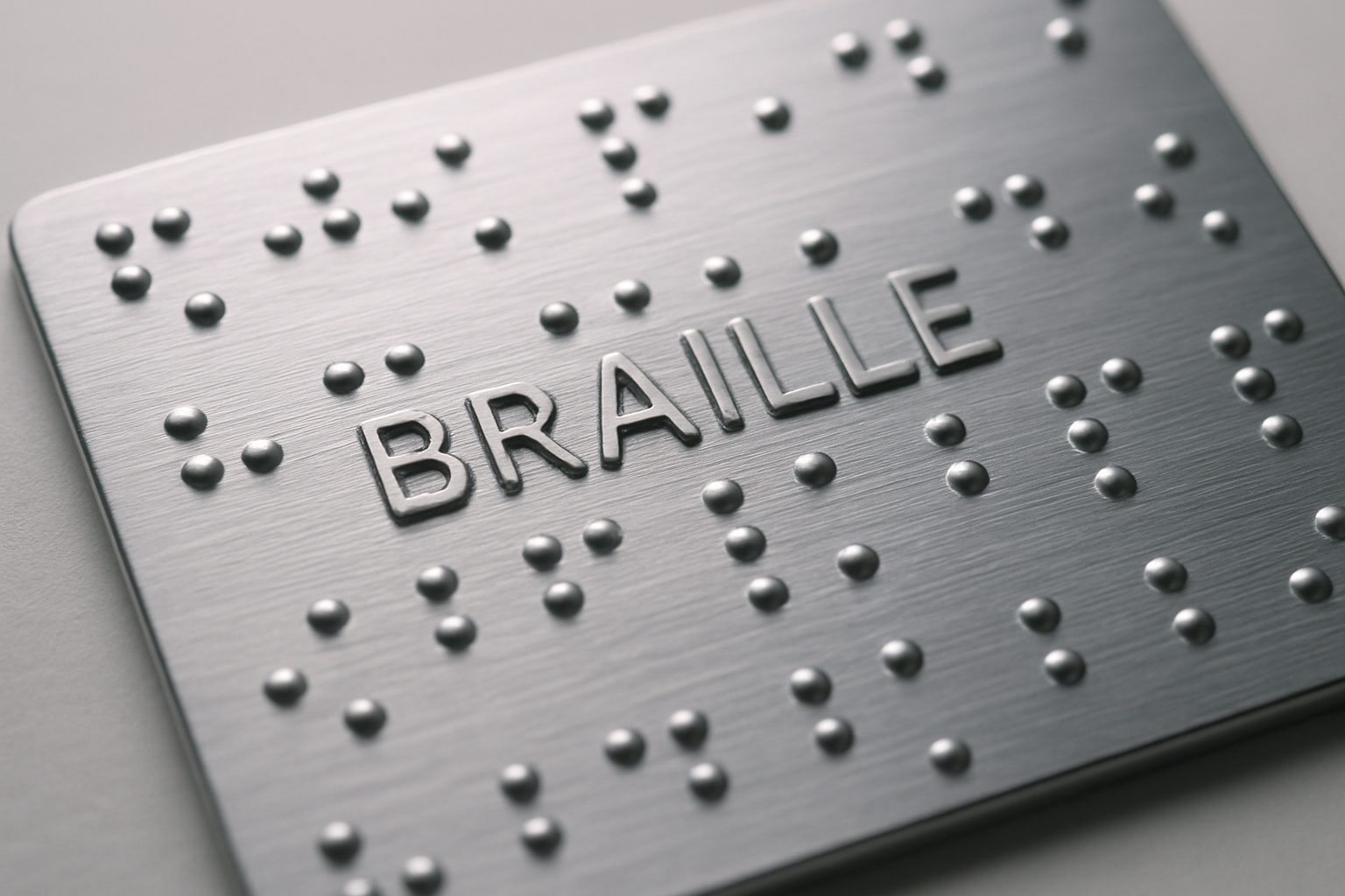Close-up of aluminium embossed Braille letters