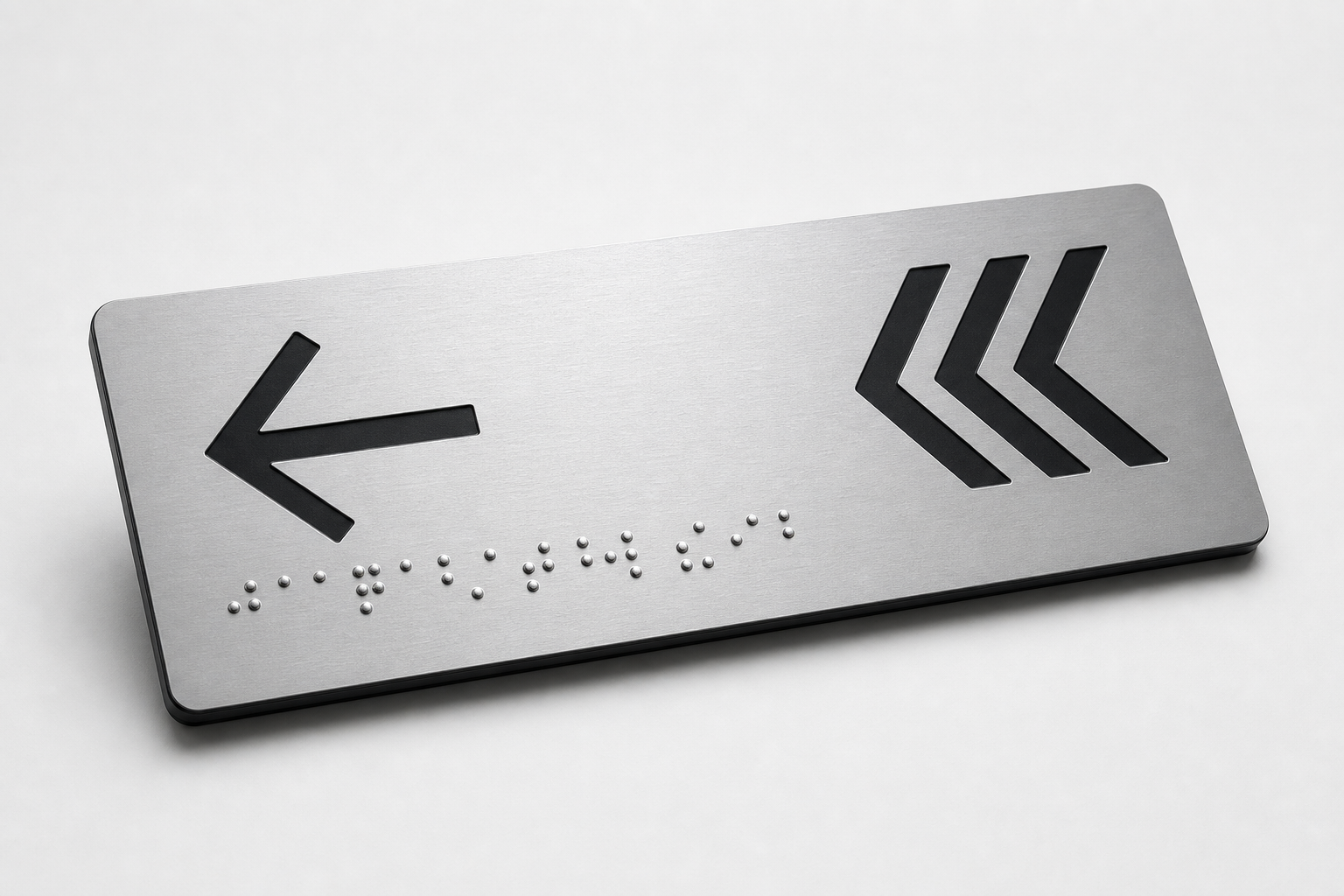 Silver directional plate with tactile arrows and high-contrast lettering