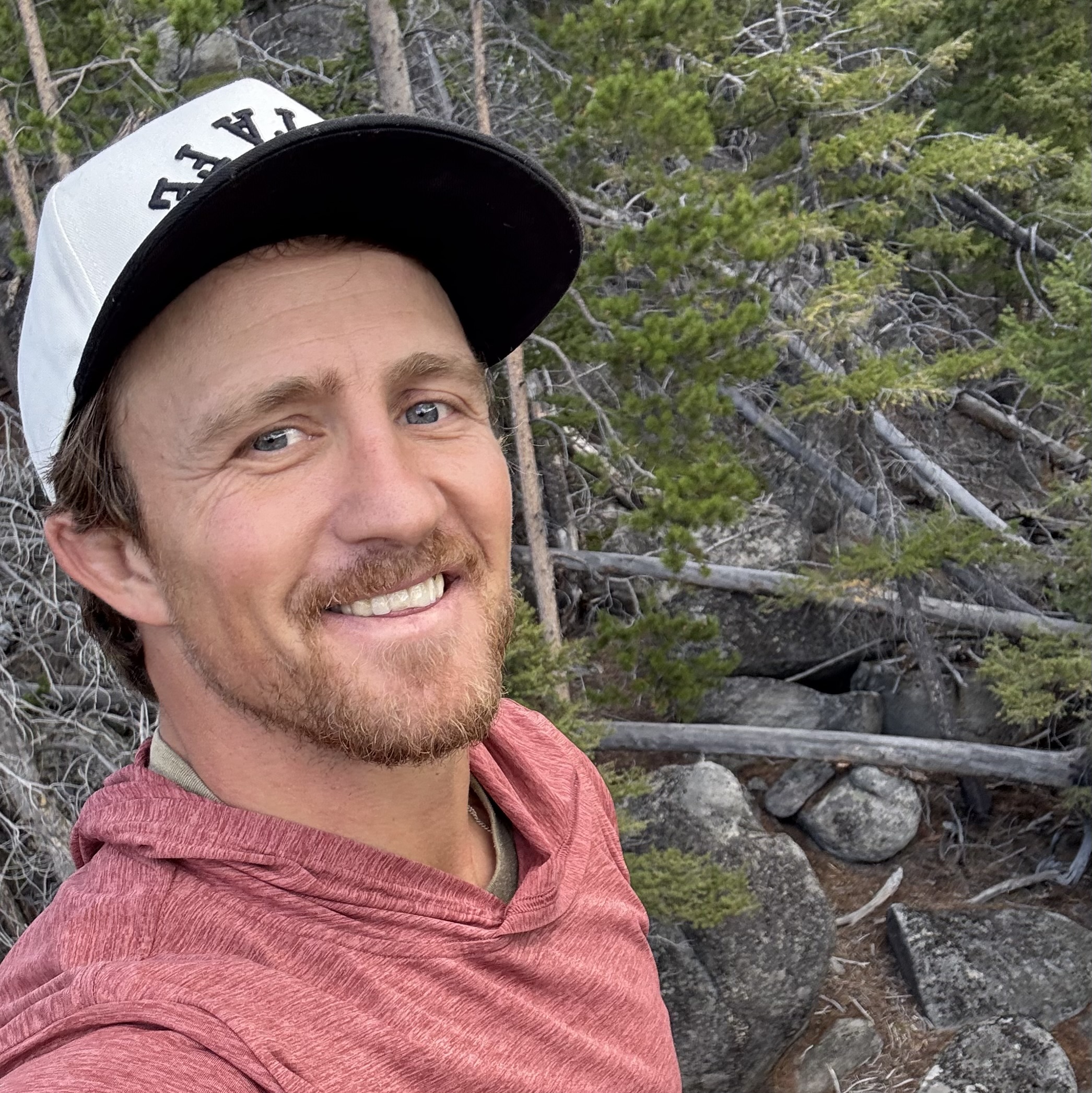 Wesley Richard smiling in a natural outdoor setting