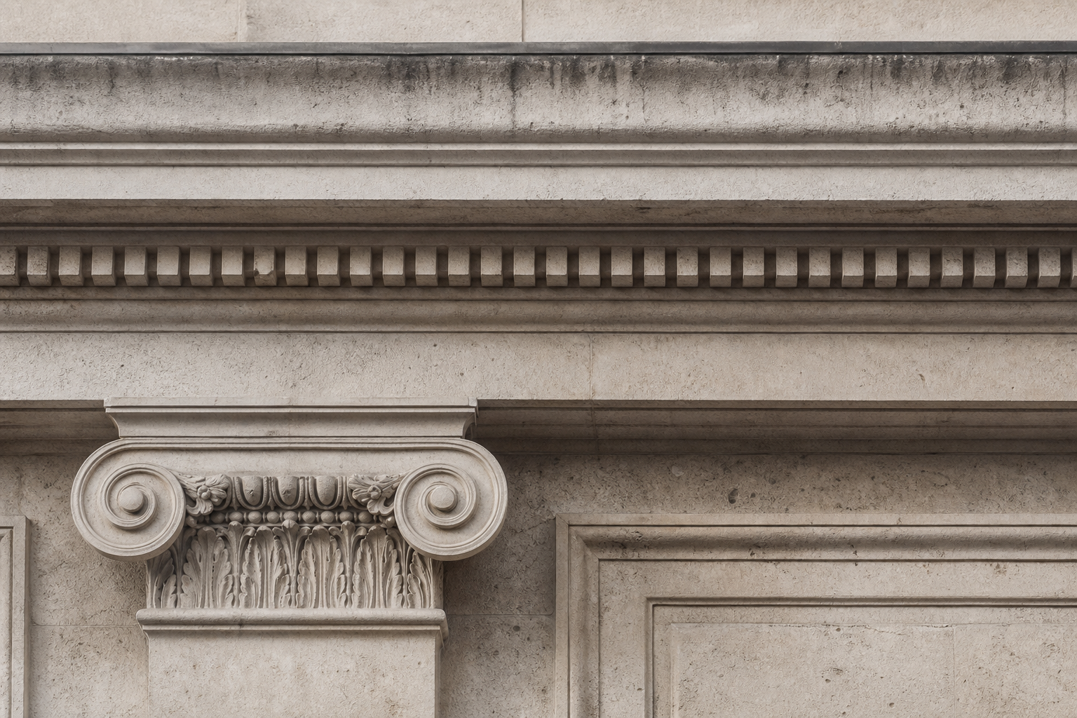 Narrow architectural cornice detail from a British stone façade, photographed straight-on with soft natural light