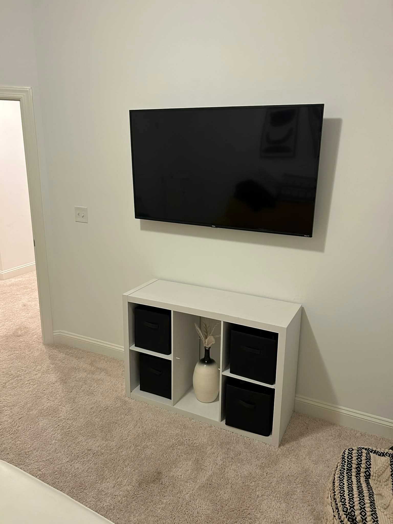 Wall-mounted TV with centered soundbar and clean cable management in a bright Apex family room