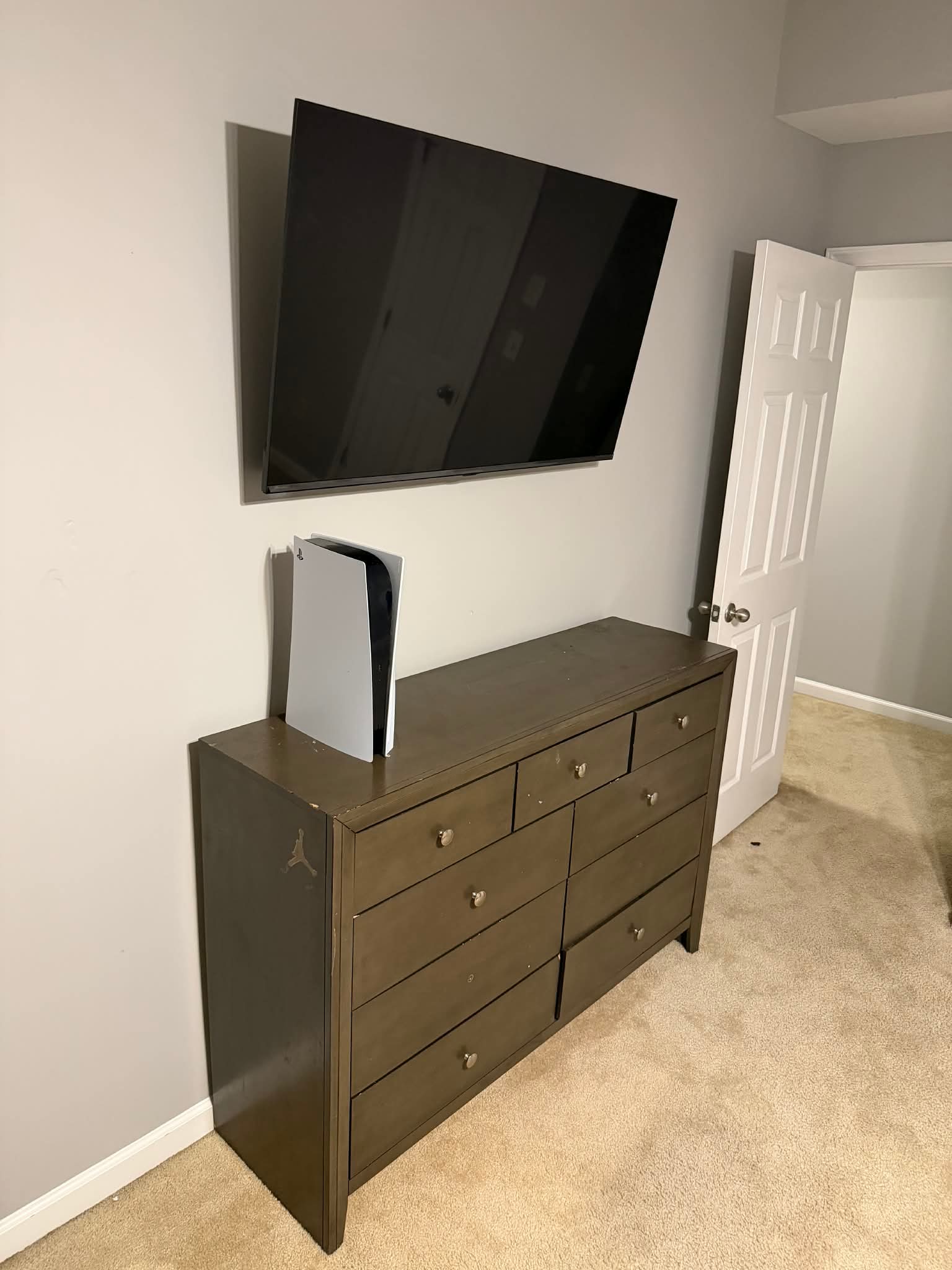 Flat-screen TV professionally mounted above a white mantel with in-wall wire concealment in a Durham home