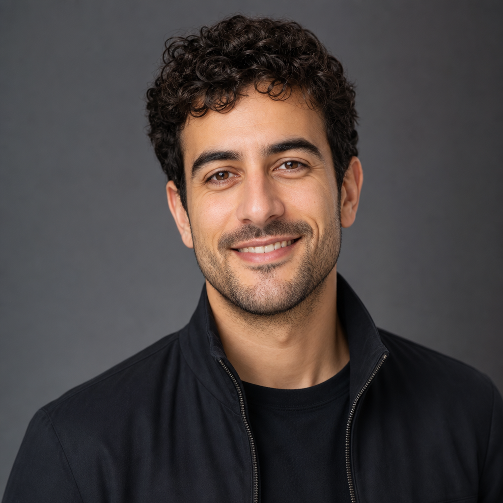 Portrait of a startup founder with short curly hair and a warm smile