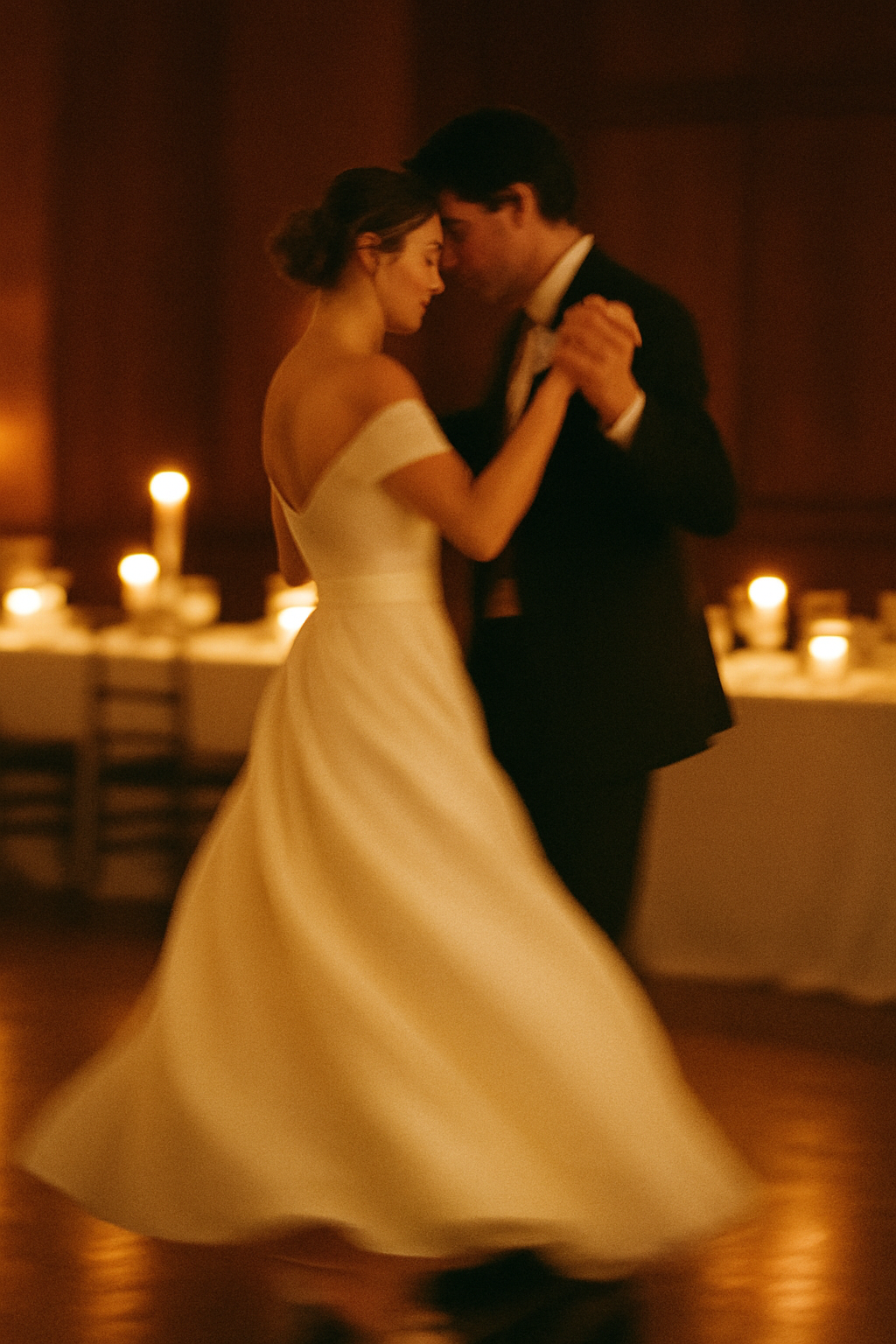 Newlyweds sharing a first dance in a candlelit hall, grainy film look