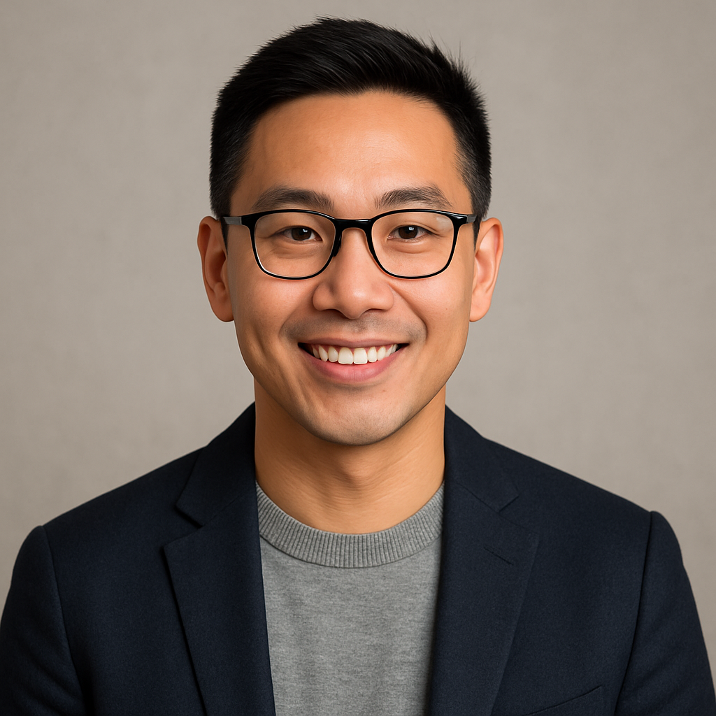 Photo of Marcus Lee, cheerful freelance designer in a modern studio, smiling at the camera with design materials on the desk.