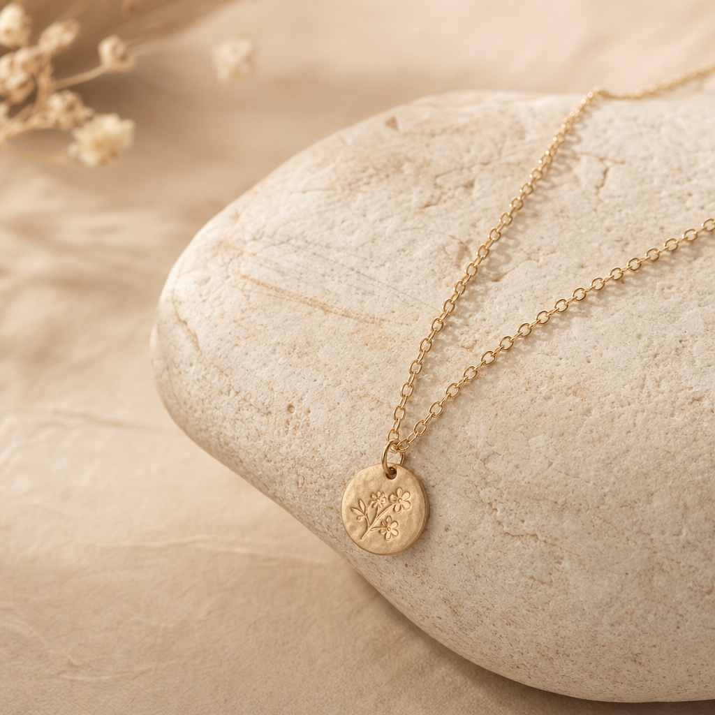 Thin gold pendant necklace on natural stone