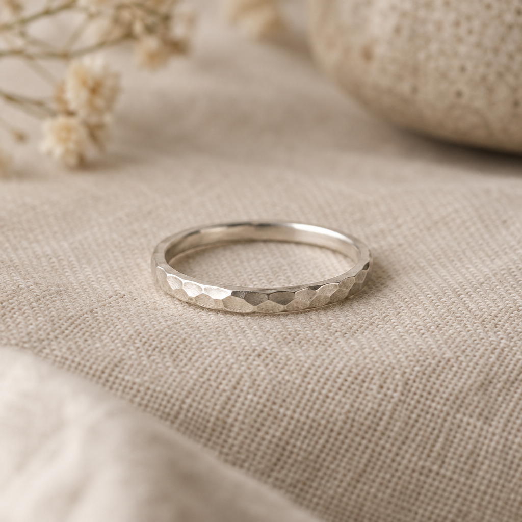 Slender hammered silver stacking ring with an artisan satin finish