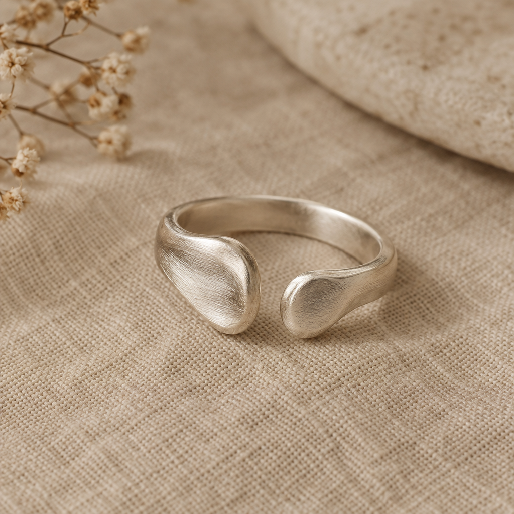 Wide organic sterling silver open ring with softly irregular sculptural ends