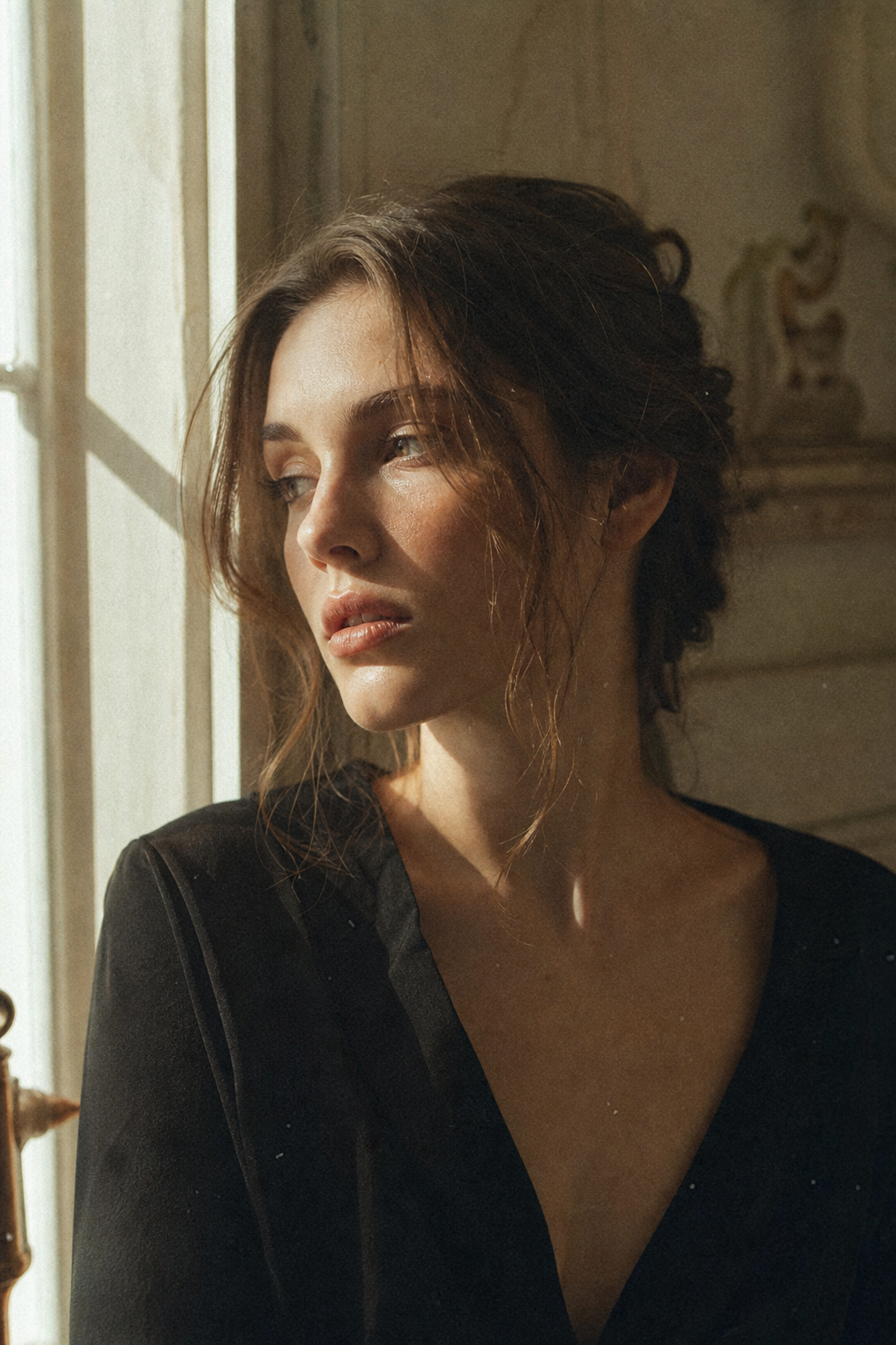 Grainy analog film portrait of a woman lit by soft window light, muted warm tones