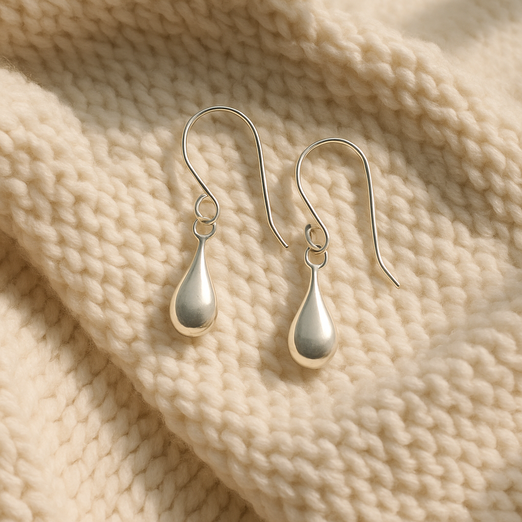 Delicate earrings on soft fabric