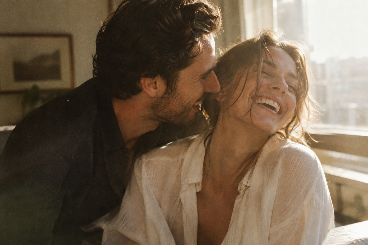 Warm-grain 35mm film photograph of a couple laughing together in a sunlit room